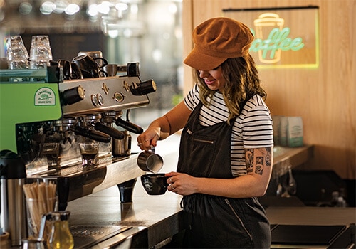 Barista pours handcrafted Chameleon coffee