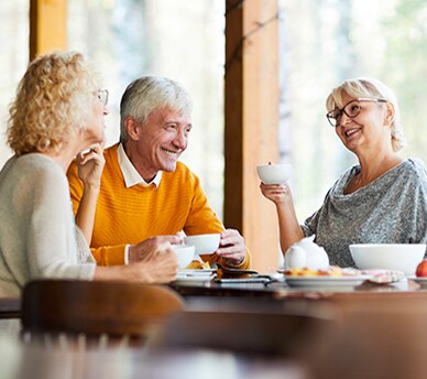 Group Enjoying Coffee in a Senior Living Community Residential Café