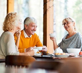 Group Enjoying Coffee in a Senior Living Community Residential Café