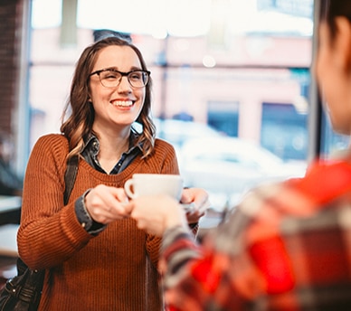 Barista Serving Coffee to Customer in Luxury Apartment Complex