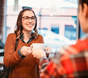 Barista Serving Coffee to Customer in Luxury Apartment Complex