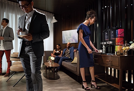 People Enjoying Coffee in Front of Self Serve Coffee Machines