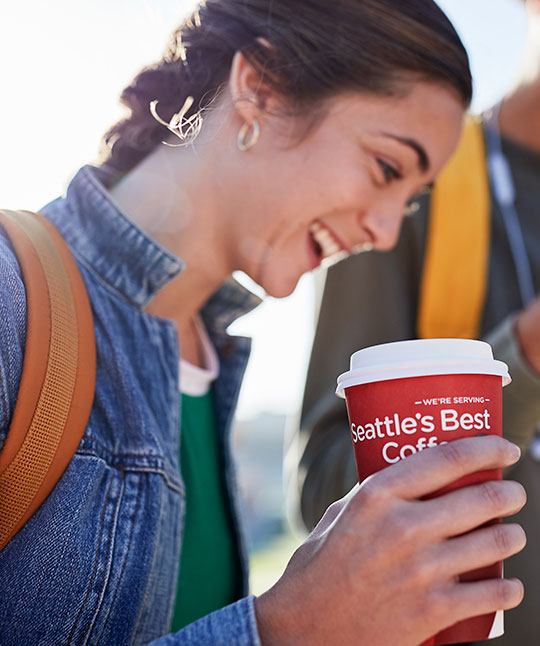 Woman Holding a Hot Cup of Seattle’s Best Coffee